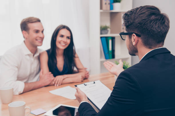 istock Happy young family working with real estate agent 948736846