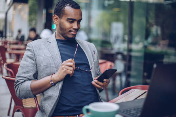 istock Man sitting in coffee shop and texting 948736964