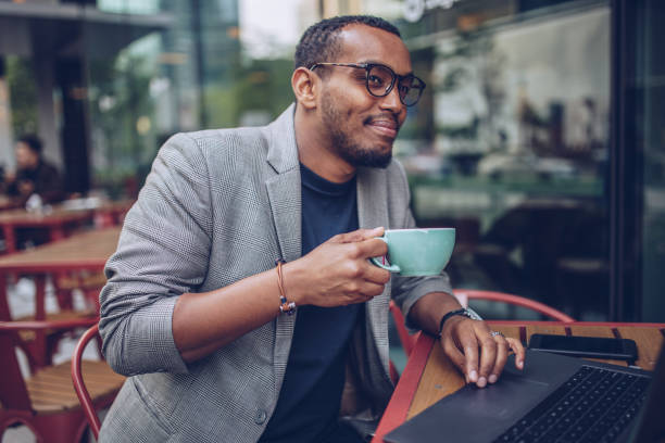istock Man sitting in coffee shop and drinking coffee 948737230