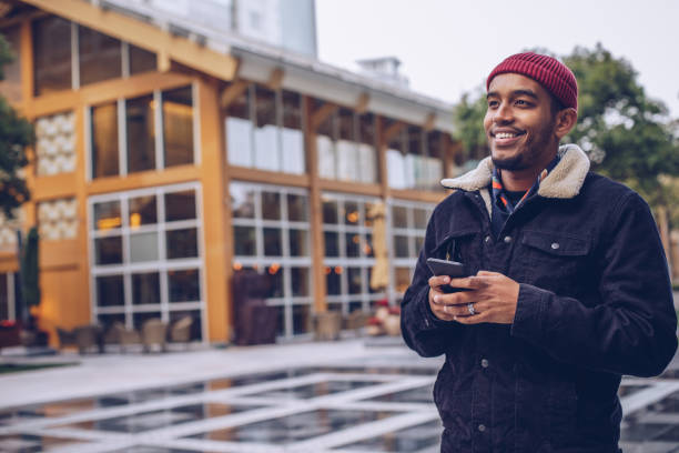 istock Man texting on phone outdoors 948739544
