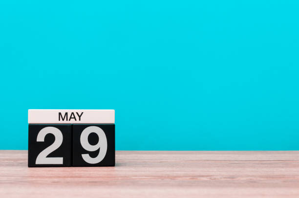 istock May 29th. Day 29 of month, calendar on turquoise background. Spring time, empty space for text 948743754