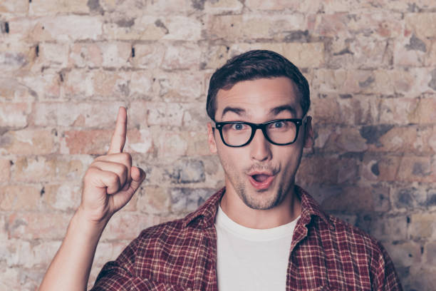 istock Happy young nerd guy raising his finger having an idea 948743904