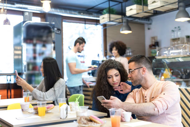 istock Couple taking selfiesocial networking in cafe 948751794
