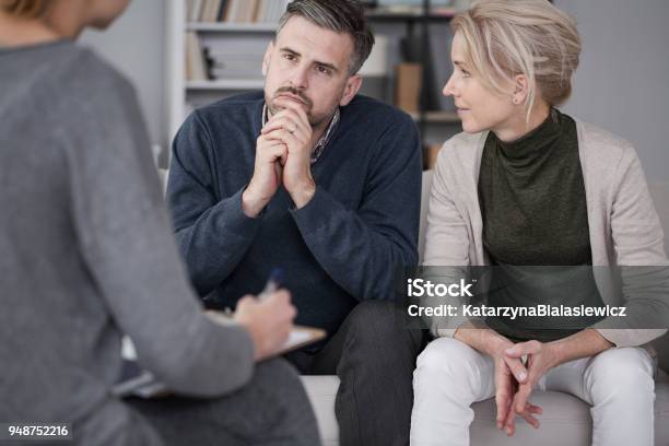Wife Supporting Husband In Therapy Stock Photo - Download Image Now - Couple - Relationship, Psychotherapy, Healthcare And Medicine