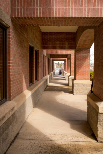 istock Brick building archway with light and shadows streaming in 948755842