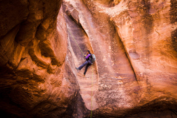 istock Athletic Young Woman Rappelling Near Moab Utah 948772578