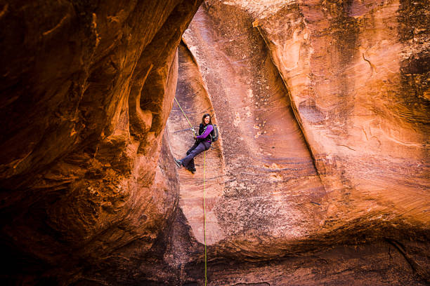 istock Athletic Young Woman Rappelling Near Moab Utah 948772580