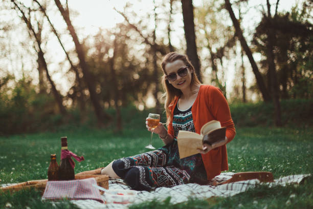istock Young woman having picnic and reading a book 948775392