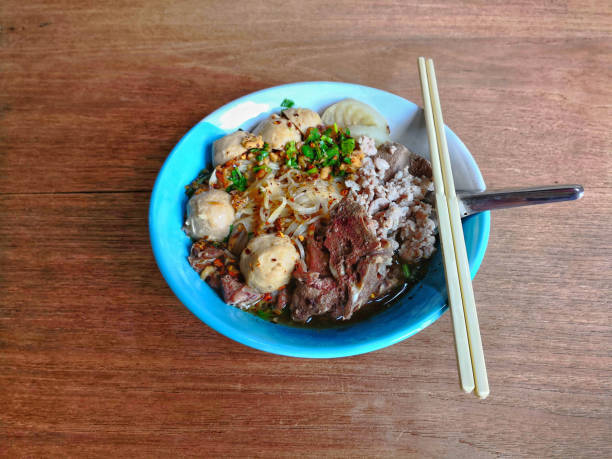 istock Rice stick noodles with pork on wood texture surface background 948783136