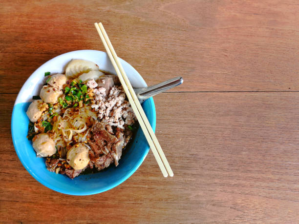 istock Rice stick noodles with pork on wood texture surface background 948783206