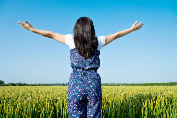 istock Woman standing in a rice field 948793622