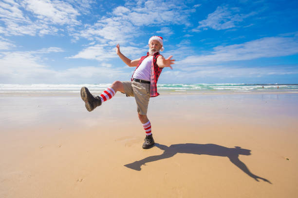 Australian Santa Claus dancing on the beach after Christmas