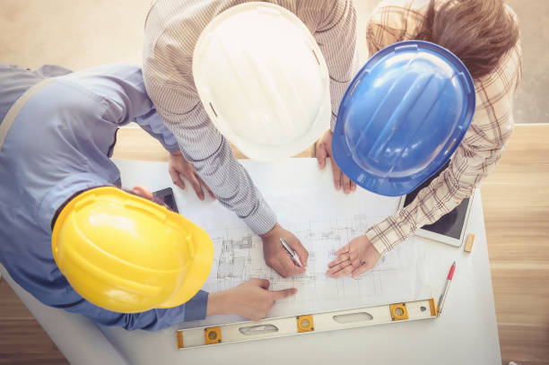 istock High Angle View Of Architects Working Over Blueprint At Table 948801372
