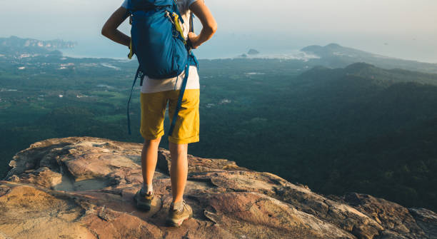 istock succesful young woman hiker on mountain top 948812196