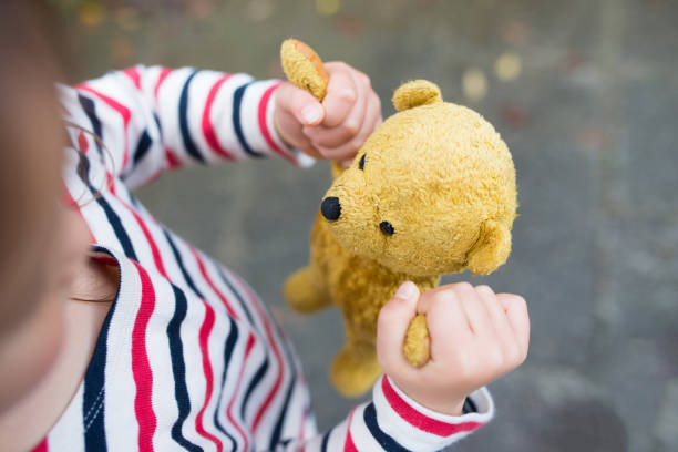 Little girls playing with teddy bear