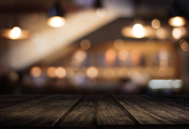 istock Wooden board empty table  cafe, coffee shop, bar blurred background can be used for display or montage your products and Mock up 948834218