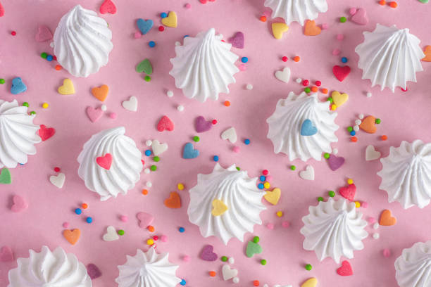 istock twisted meringues with confectionary decorations on pink background. 948843098