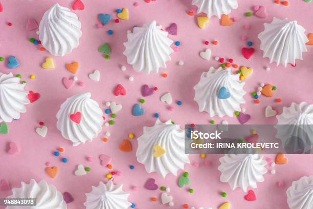 Twisted Meringues With Confectionary Decorations On Pink Background Stock Photo - Download Image Now
