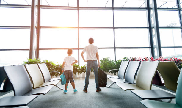 istock Father and son waiting at airport 948856272