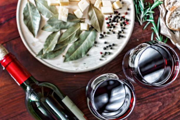 Red wine in glasses on a dinner table,cheese snacks. bread top view