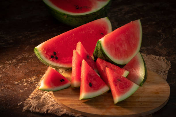 istock watermelon and watermelon pieces in a wooden background 948860330
