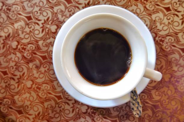 istock Coffee in white glass top view. 948860528