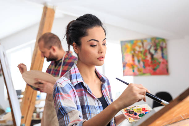 istock FIne art painters working together in atelier 948860638