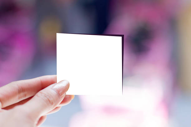 istock A woman hand holding empty white  card on  blur purple in background with shadow 948860838