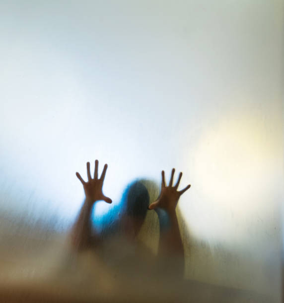 istock Child hands touching frosted glass 948863518