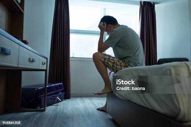 Man Sitting On Bed With Head In Hands Stock Photo - Download Image Now - Men, Depression - Sadness, Bed - Furniture