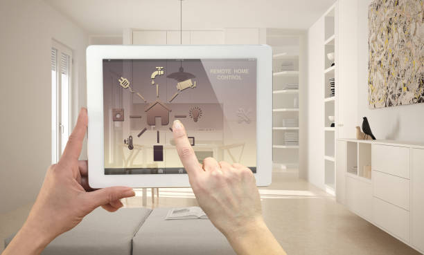 istock Smart remote home control system on a digital tablet. Device with app icons. Minimalist modern bright kitchen in the background, architecture interior design 948864798