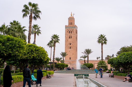Marrakesh, Morocco - November 08, 2017: View of the Koutoubia Mosque in Marrakesh from Lalla Hasna park with palm trees in the foreground