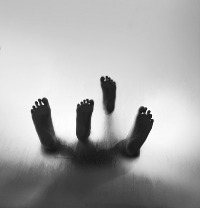 Human feet walking on frosted glass