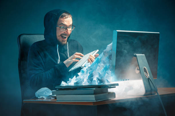 istock Young stressed handsome businessman working at desk in modern office shouting at laptop screen and being angry about spam 948868644