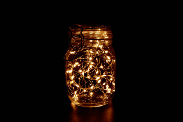 istock Fairy Light in a Glass Jar on Dark Background 948873438