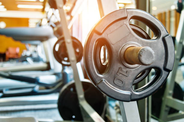 istock Metal heavy barbell laid in gym 948874842