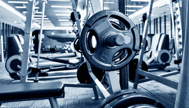 istock Metal heavy barbell laid in gym 948874954