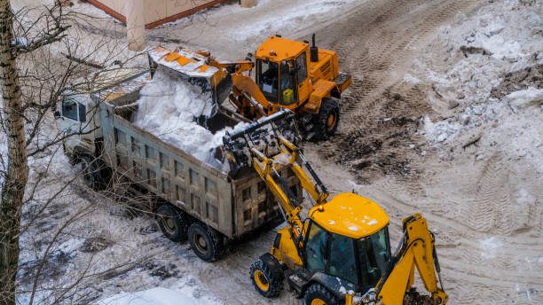 istock Snow loading by road machinery after heavy snowfall in residential block 948875128