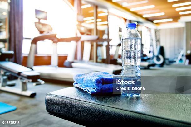 Towel And A Bottle Of Water In Gym Stock Photo - Download Image Now - Gym, Health Club, Exercising