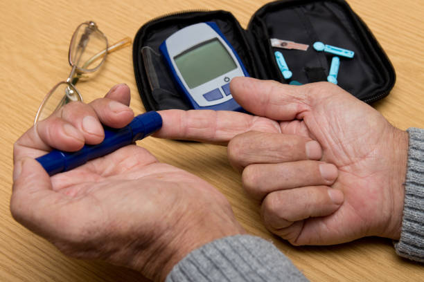 istock Concept diabetes in the elderly retired. Senior man with glucometer checking blood sugar level at home. Learn to use a glucometer 948881780