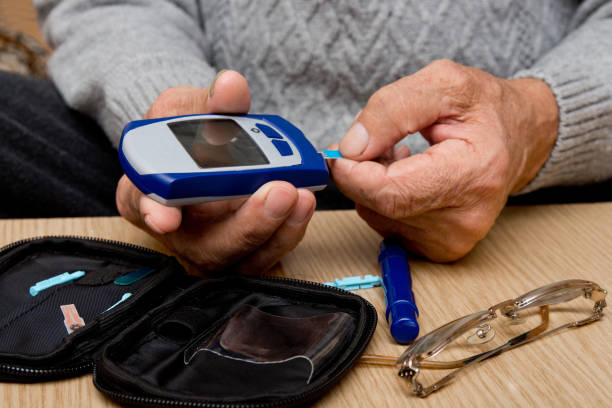 istock Concept diabetes in the elderly retired. Senior man with glucometer checking blood sugar level at home. Learn to use a glucometer 948881832