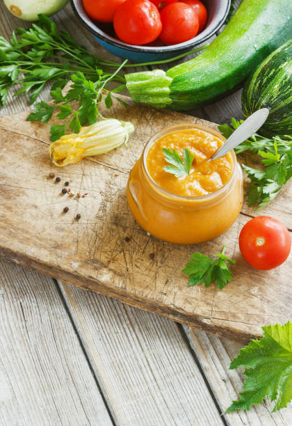 istock Squash zucchini paste in a glass jar surrounded by the ingredients 948882020