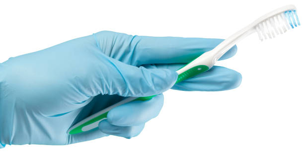 istock Toothbrush in the gloved hand 948882332