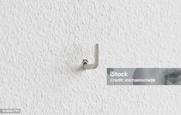 Painted Small Hook In A Wall Stock Photo - Download Image Now - Hook - Equipment, Wall - Building Feature, Chrome