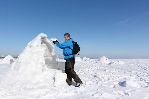 istock Man building an igloo on a snowy reservoir in winter 948883164