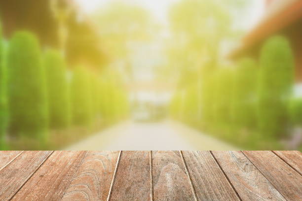 istock Empty Wooden Board with Blurred Pathway in Garden Background. 948883362