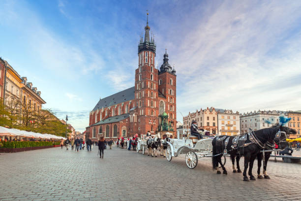Krakow, Poland - November 12, 2017: Horse carriages at the Main Square in Krakow, Poland. Krakow is the second largest and one of the oldest cities in Poland.