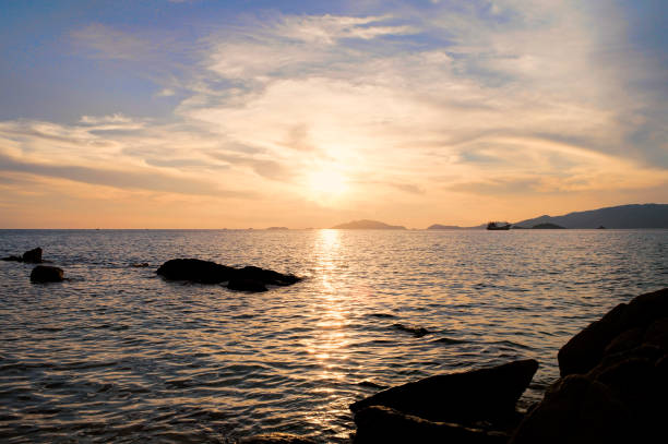 istock Beautiful landscape sunset over the ocean water reflect with cloud sky. 948887542