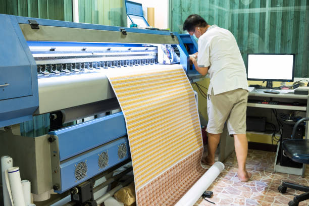istock Technician refill ink color of inkjet printer during printing card sticker 948890666