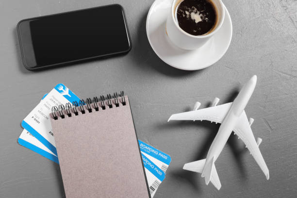 istock boarding pass and toy airplane on table top view 948891210